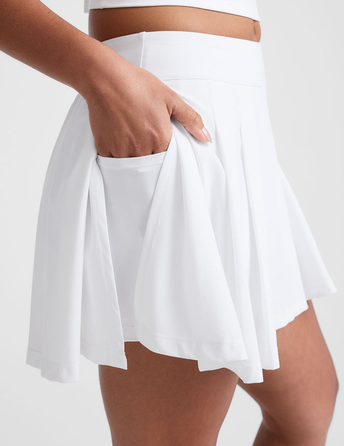 white mini pleated skirt with interior shorts with pockets.