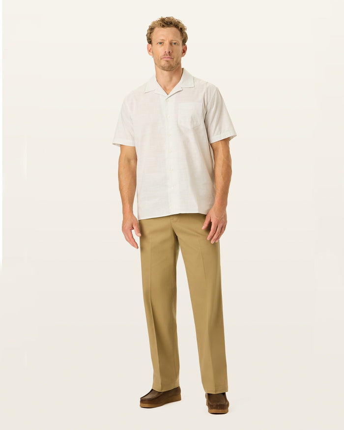 Front view of model wearing New British Khaki Signature Iron Free Khakis, Relaxed Fit with Stain Defender®.