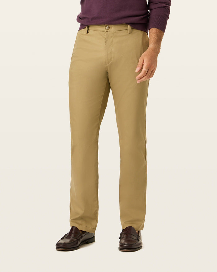 Back view of model wearing New British Khaki Signature Khakis, Straight Fit.