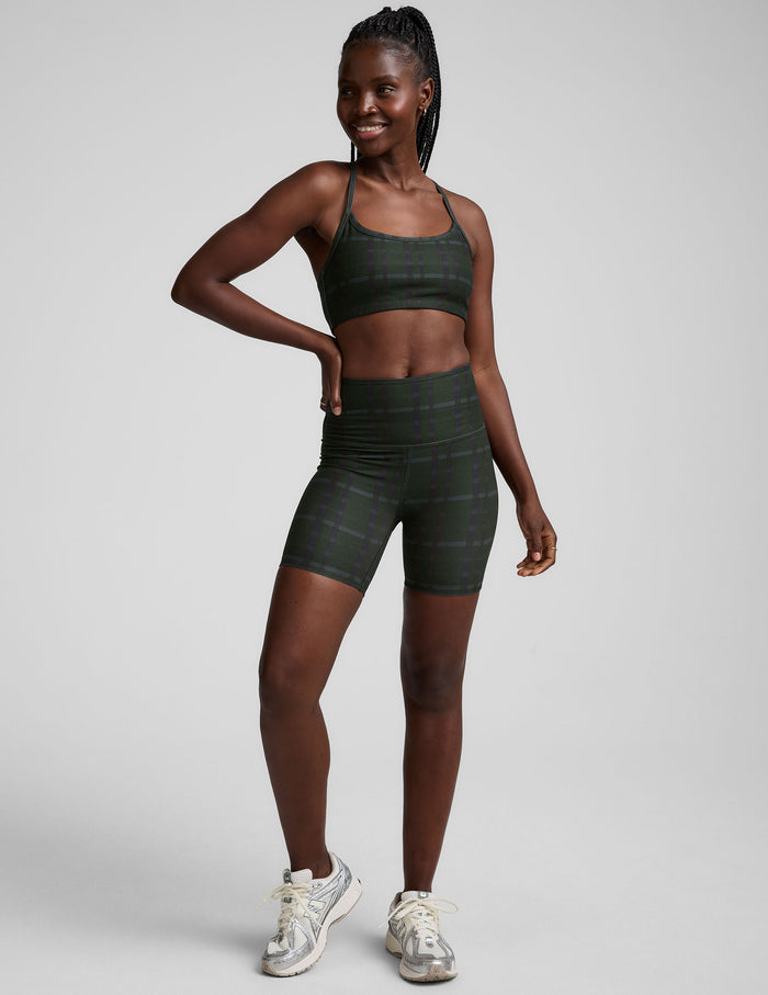 SoftMark Keep Pace Biker Short in emerald plaid with a high waistband and mid-thigh length, shown on a model.