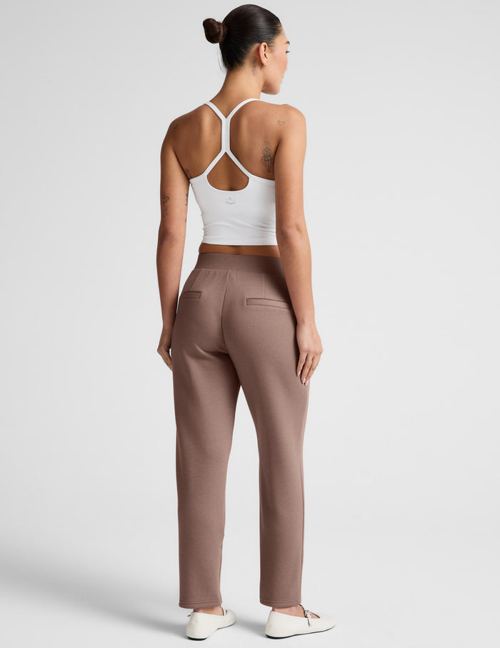Brown SoftSpring Tapered Pant shown from behind, featuring a wide elastic waistband, back welt pockets, and ankle length.