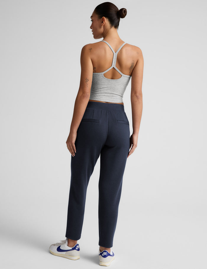 Rear view of the Navy SoftSpring Tapered Pant, a mid-rise ankle-length pant with back welt pockets and elastic waistband.