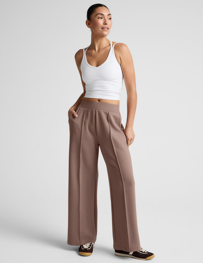 SoftSpring Wide Leg Pant 31" in beige featuring front pintucks, a mid-rise elastic waist, and side slant pockets.