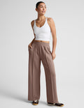 SoftSpring Wide Leg Pant 31" in beige featuring front pintucks, a mid-rise elastic waist, and side slant pockets.