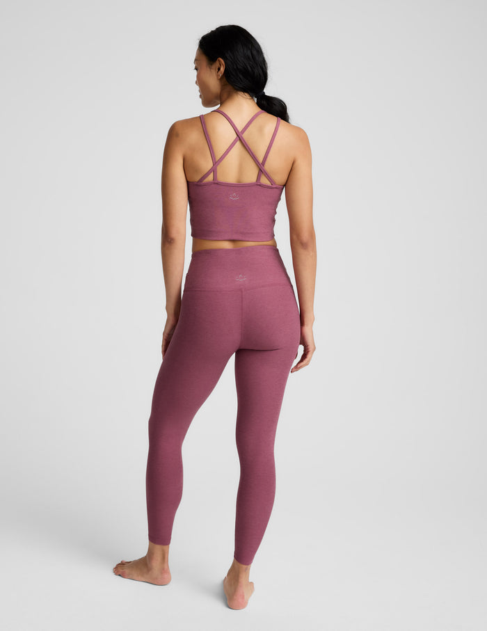 Person wearing a mauve athletic outfit on a white background.