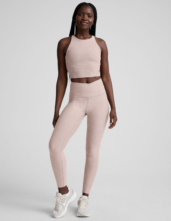 Woman wearing a chai athletic outfit on a white background
