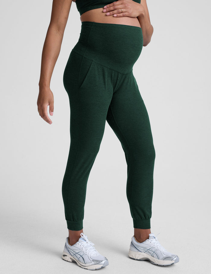 Emerald Spacedye Beyond the Bump Maternity Midi Jogger with a high-rise waistband and slim tapered fit on a pregnant model.