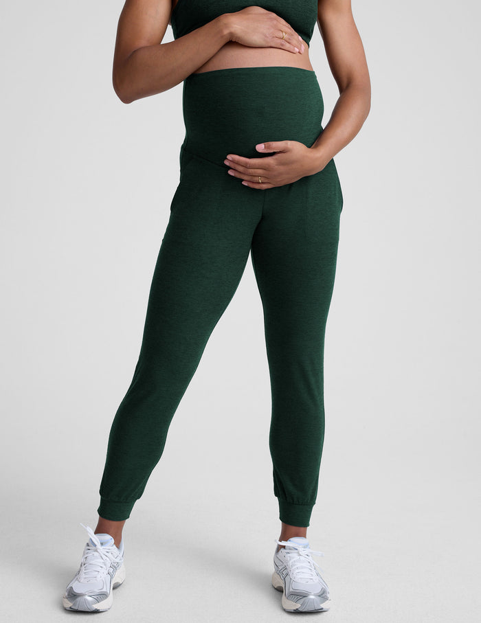 Emerald Spacedye Beyond the Bump Maternity Midi Jogger in dark green on a pregnant model with an over-the-bump waistband.