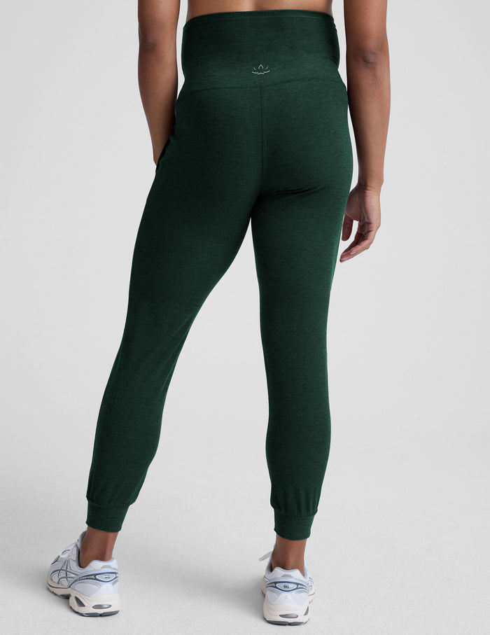 Rear view of emerald Spacedye Beyond the Bump Maternity Midi Joggers with a high waistband and tapered cuffed ankles.