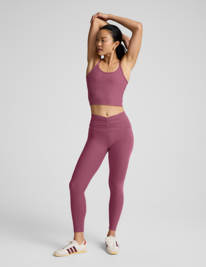 Person wearing a purple athletic outfit on a light gray background.