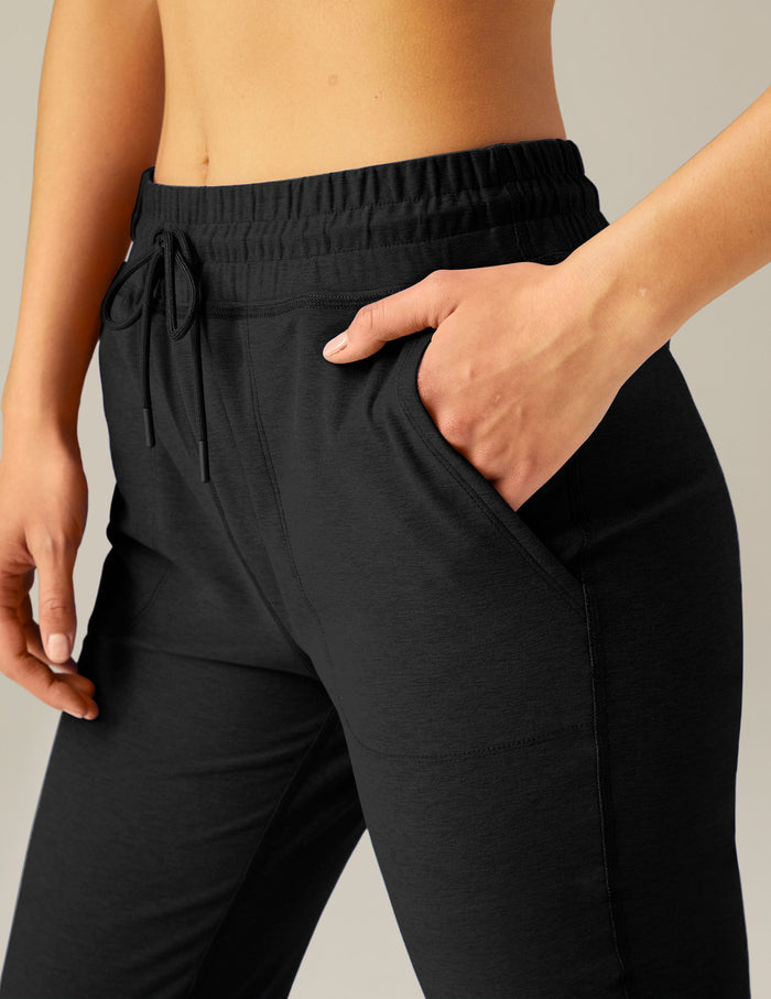 Black Spacedye Commuter Midi Jogger with hand in pocket, showing marled texture, high waistband, and drawstrings.