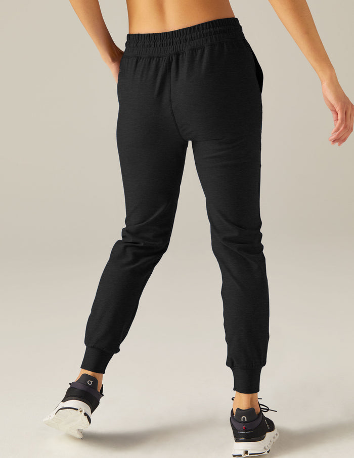 Back view of black Spacedye Commuter Midi Jogger featuring a slim fit, gathered waistband, and tapered banded ankle cuffs.