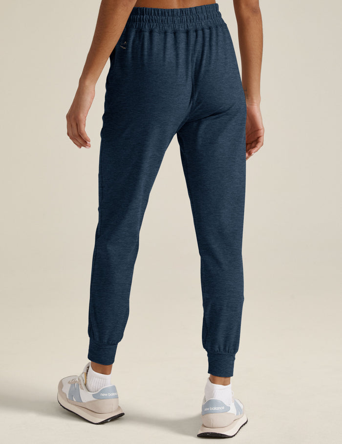 Rear view of navy marled Spacedye Commuter Midi Jogger with a slim fit, gathered high waistband, and banded ankle cuffs.