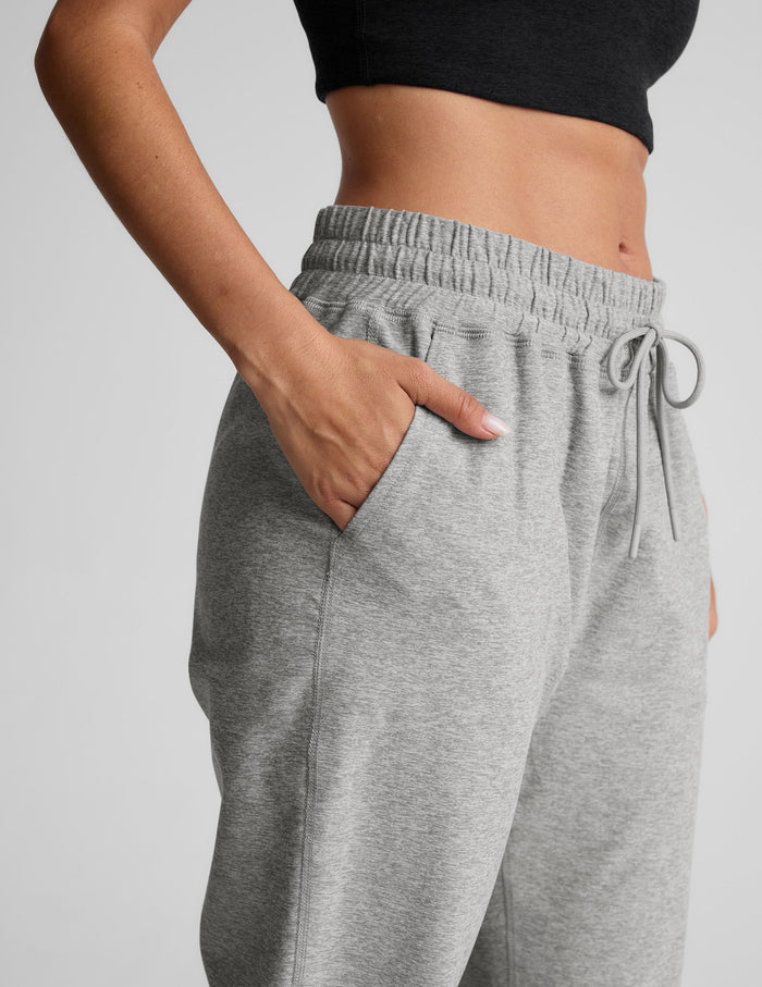 Gray marled Spacedye Commuter Midi Jogger showing the high elastic waistband, drawstring, and hand in a side slant pocket.