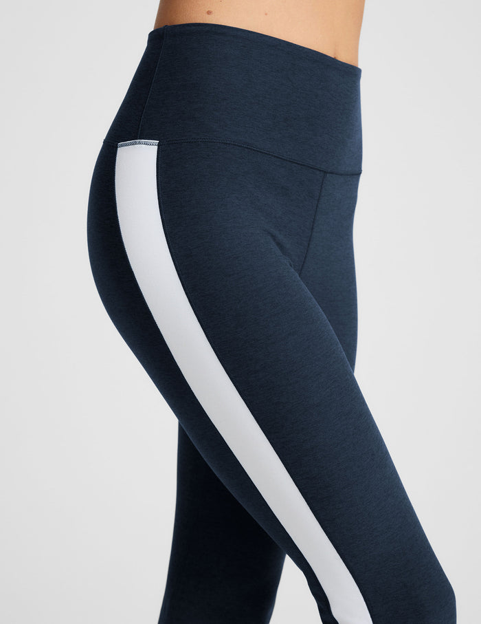 Side view of navy Spacedye Gemini Colorblock Side Slit Pant featuring a high waist and a white vertical side stripe.