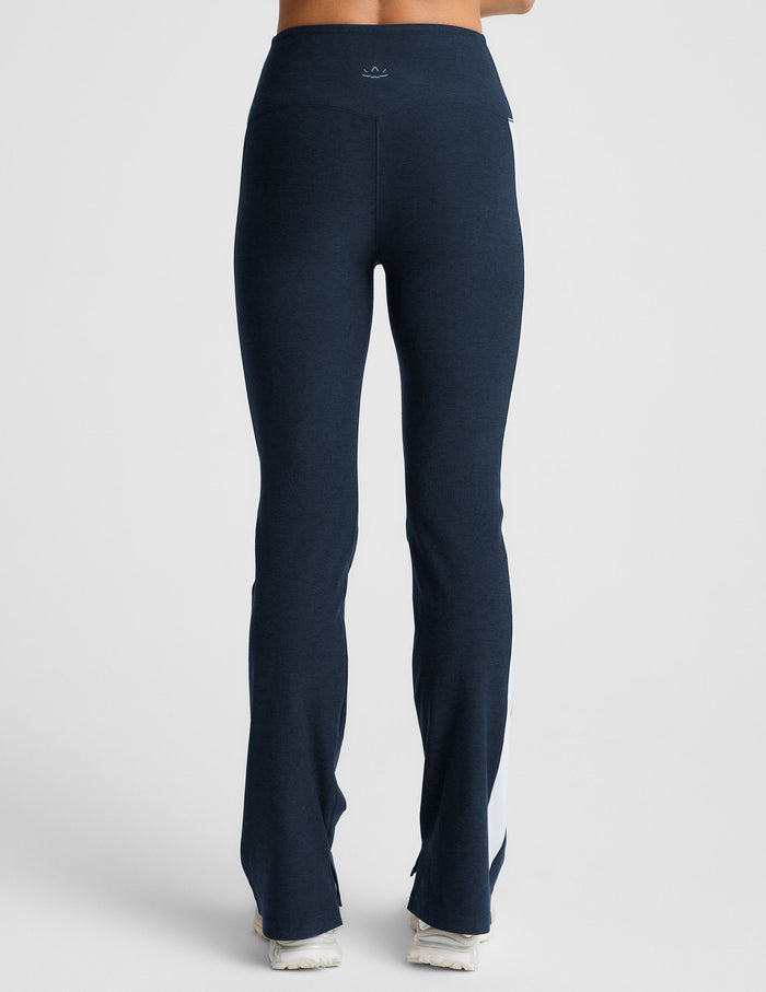 Rear view of Spacedye Gemini Colorblock Side Slit Pant in navy with white side panels, high waist, and bootcut leg slits.