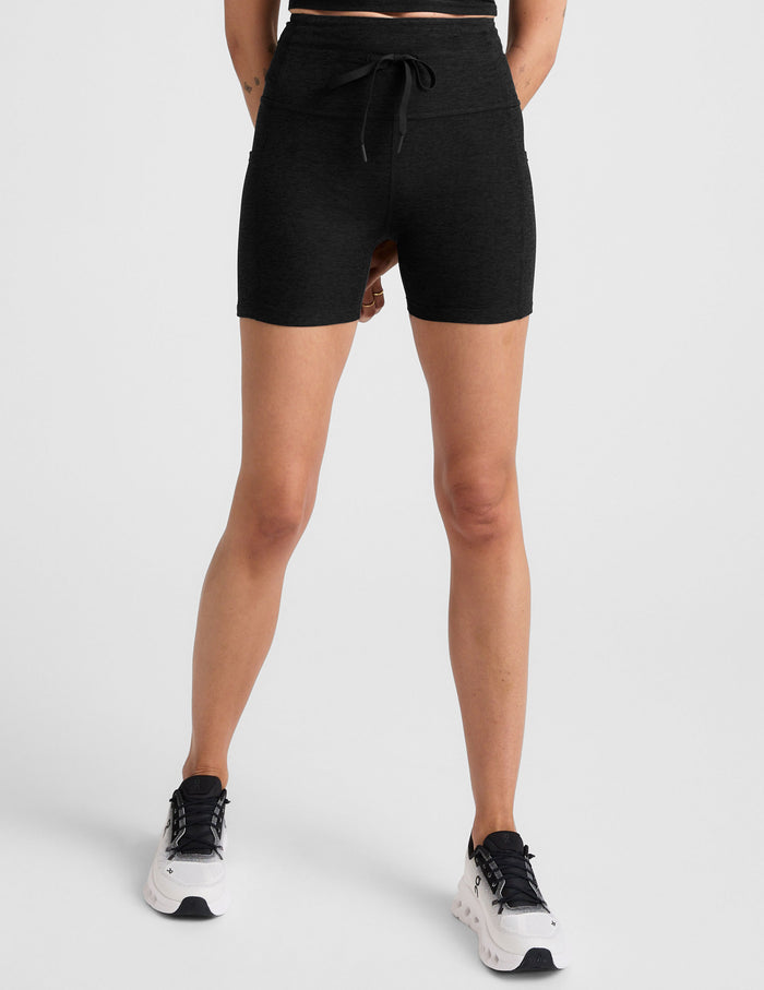Black Spacedye Go Pocket 5" Short on a model, showing the high waistband, drawstring tie, side pockets, and mid-thigh fit.