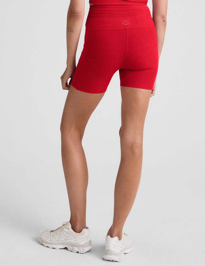 Back view of red Spacedye Go Pocket 5" Short, a high-waisted, heathered bike short with a snug fit hitting at mid-thigh.