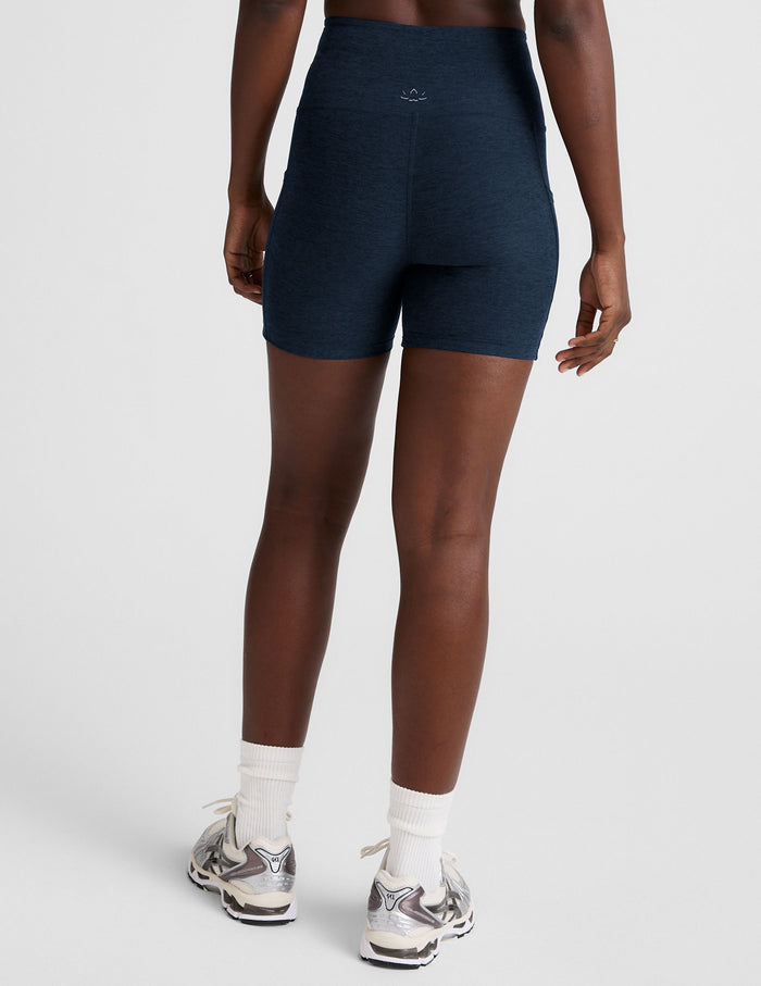 Rear view of navy Spacedye Go Pocket 5" Short, high-waisted bike shorts with a snug fit and heathered texture.