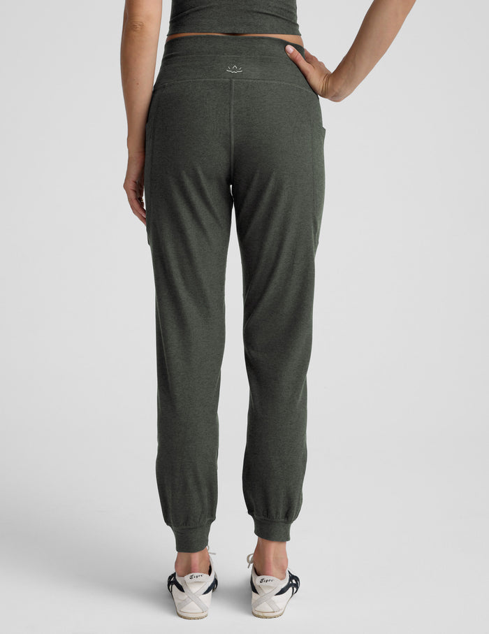 Rear view of olive Spacedye Go Pocket Jogger featuring a high waist, side pockets, and cuffed hems on a model.