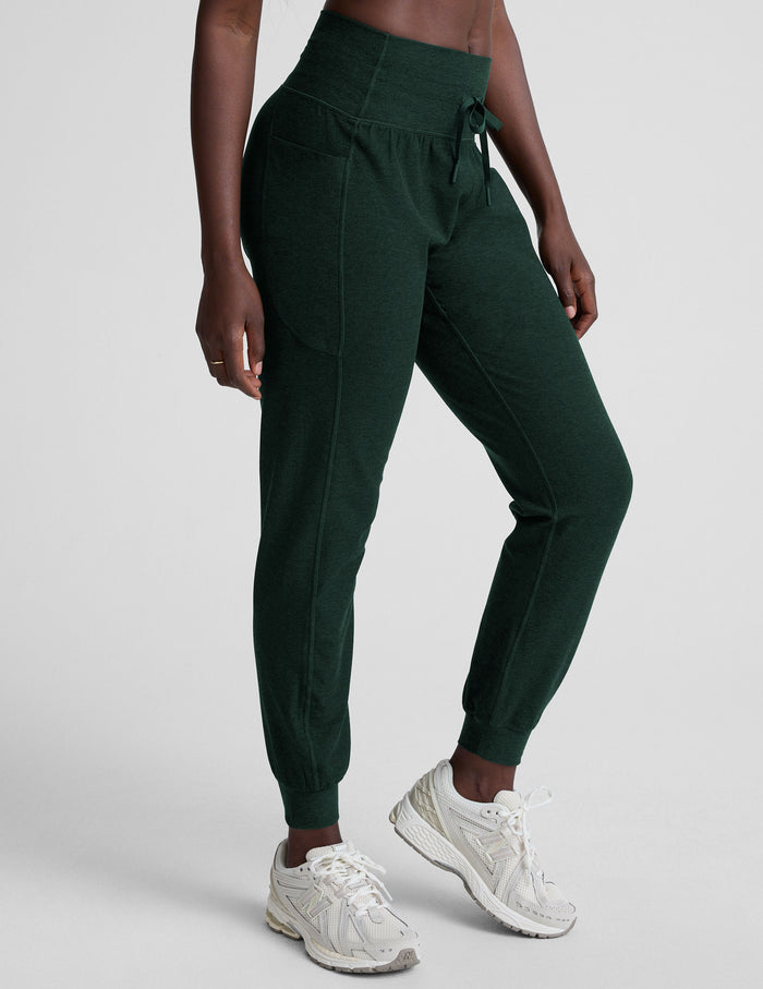 Model wearing emerald Spacedye Go Pocket Joggers with a high drawstring waist, side pockets, and tapered cuffed ankles.