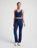 Woman wearing blue Spacedye High Waisted Practice Pocket Bootcut Pant 31" with a matching crop top and white sneakers.