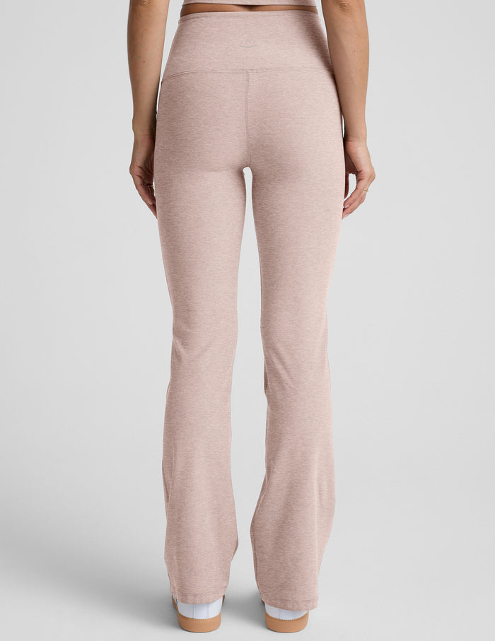 Woman wearing Pink Spacedye™ High Waisted Practice Pocket Bootcut Pant, rear view, paired with white sneakers.