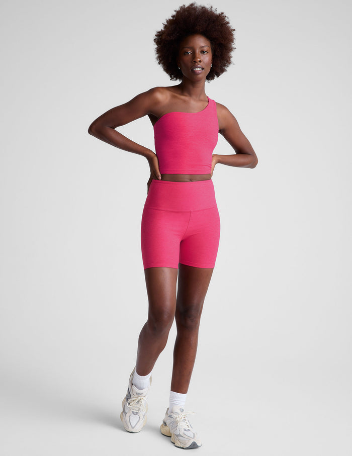 Front view of a woman wearing the marled fuchsia Spacedye Keep Pace 5" Short with a high waistband and matching crop top.