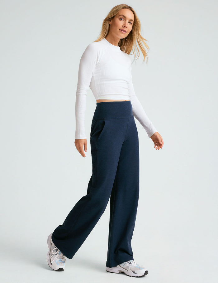 Woman wearing navy Spacedye Laid Back Wide Leg Pant with a high waistband and side pockets, styled with a white long-sleeve.
