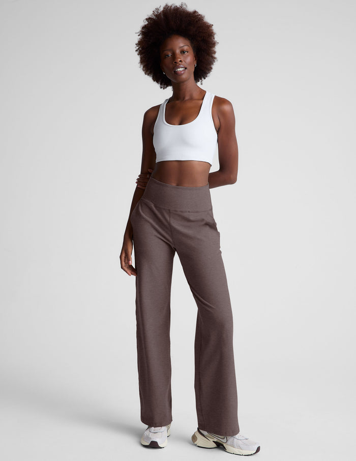 Brown Spacedye Laid Back Wide Leg Pant with a high waistband and relaxed fit, modeled with a white top and sneakers.