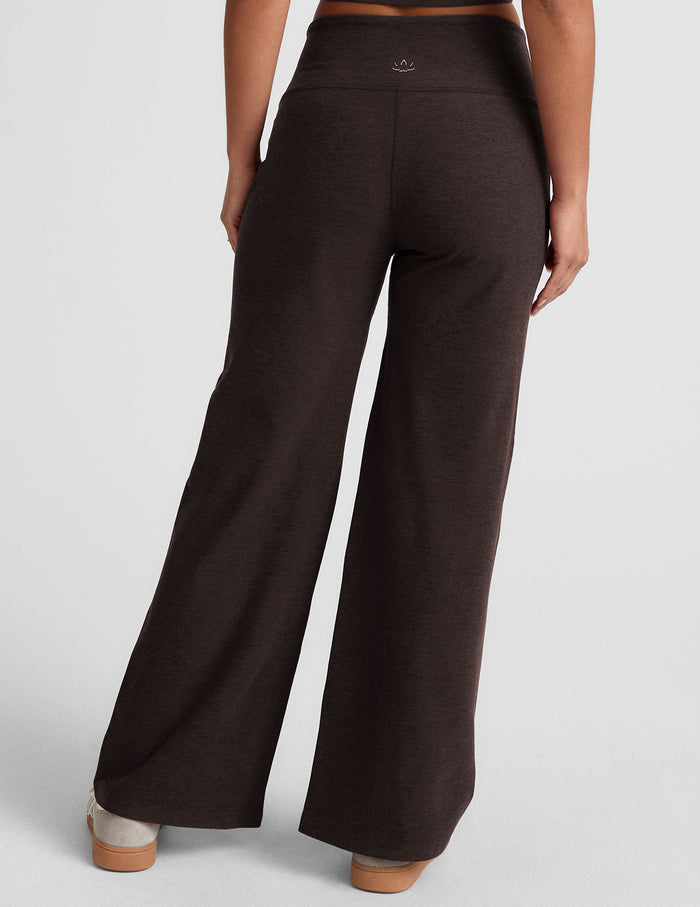 Rear view of woman wearing Brown Spacedye Laid Back Wide Leg Pant™ paired with a matching top and cream sneakers.