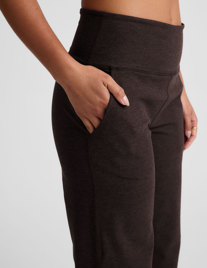 Woman wearing Brown Spacedye Laid Back Wide Leg Pant with hand in slant pocket, paired with a bare midriff.
