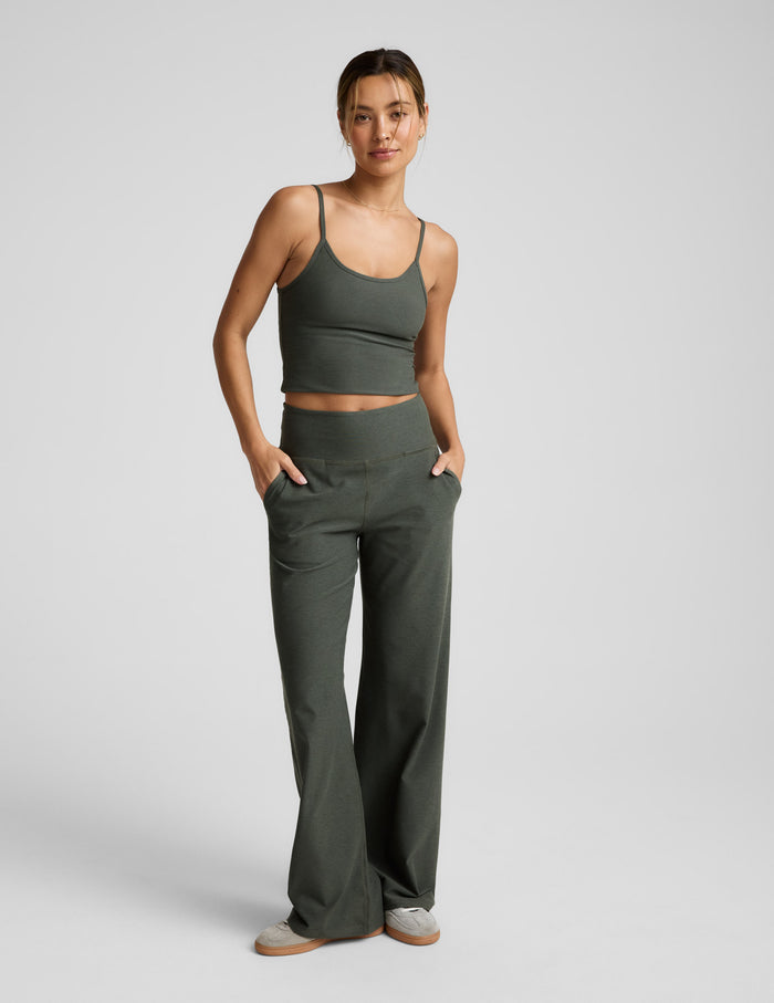 Woman wearing olive Spacedye Laid Back Wide Leg Pant 31" featuring a high waistband and side pockets on a gray background.