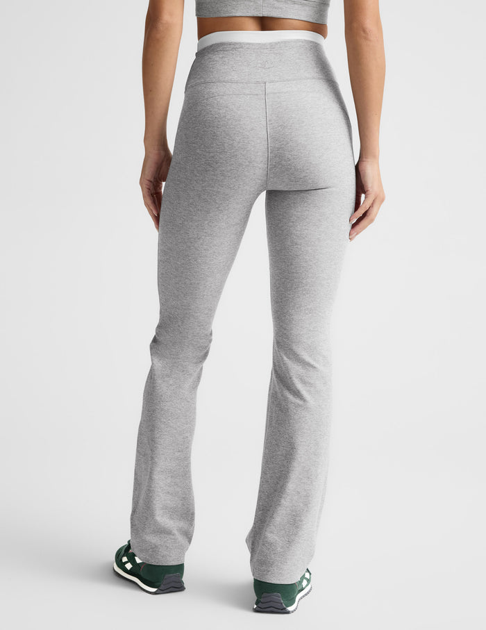 Rear view of the gray Spacedye Layered Bootcut Pant featuring a white contrast waistband and snug fit with a flared hem.