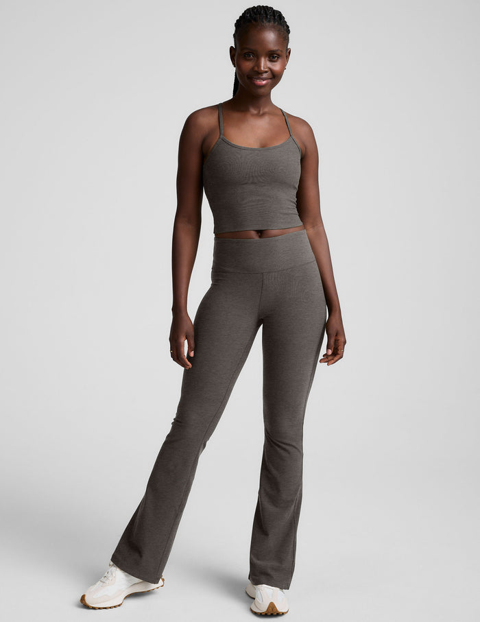 Smiling model in dark grey Spacedye Mid-Rise Bootcut Pant with a flared hem and marled texture, full-length studio shot.