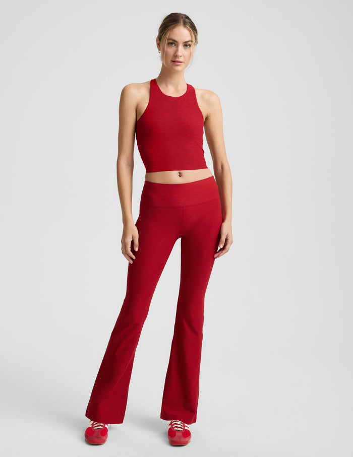 Front view of a model wearing red Spacedye Mid-Rise Bootcut Pant with a wide waistband and flared leg silhouette.