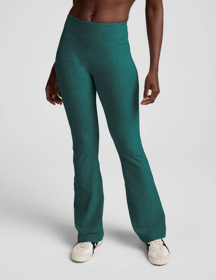 Model wearing the teal Spacedye Mid-Rise Bootcut Pant with a snug fit, wide waistband, and flared leg in heathered jewel tone.