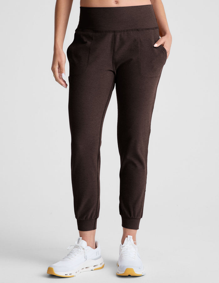 Dark brown Spacedye Midi Jogger with a high waistband, side pockets, and cuffed ankles, paired with white sneakers.