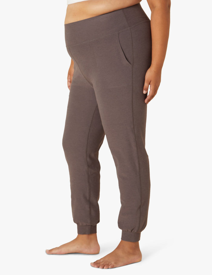 Side view of brown Spacedye Midi Jogger featuring a wide waistband, side pockets, and tapered legs with banded ankle cuffs.