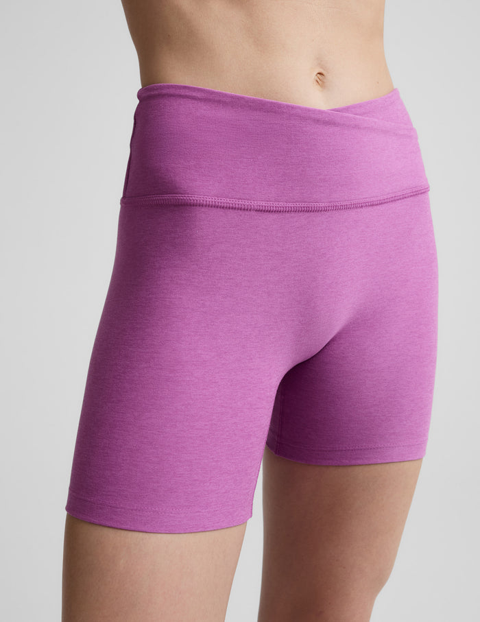 Woman wearing Purple Spacedye™ At Your Leisure 5" Biker Short with a bare midriff, showing the overlapping V-waistband.