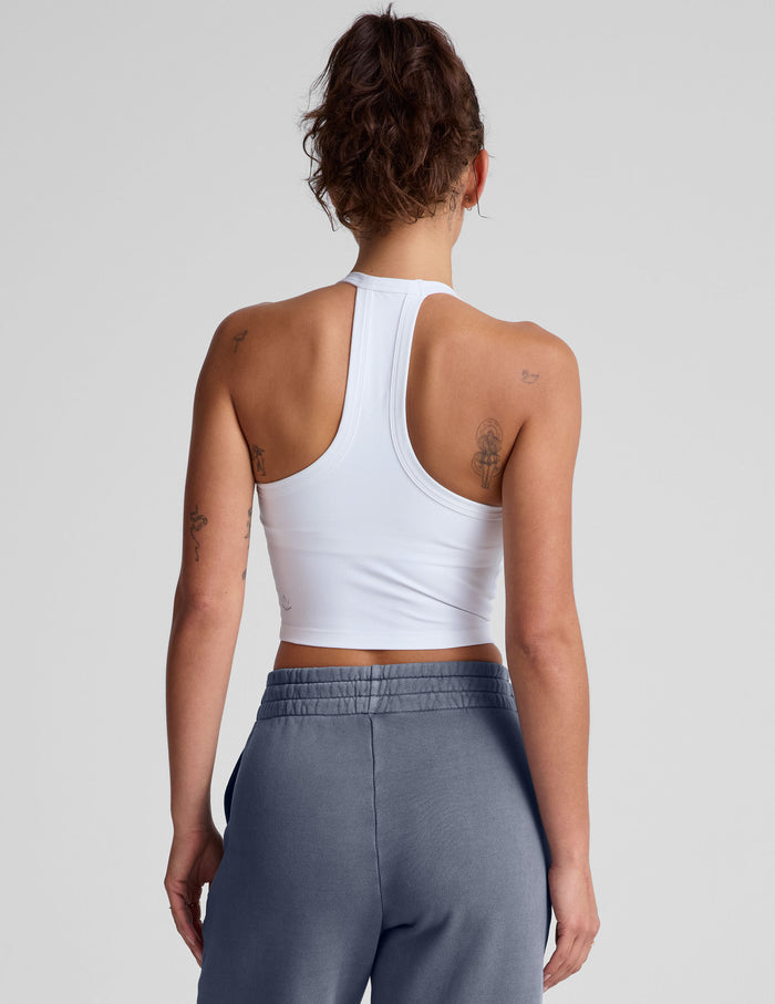 white cropped tank top with a v neckline and high racerback.