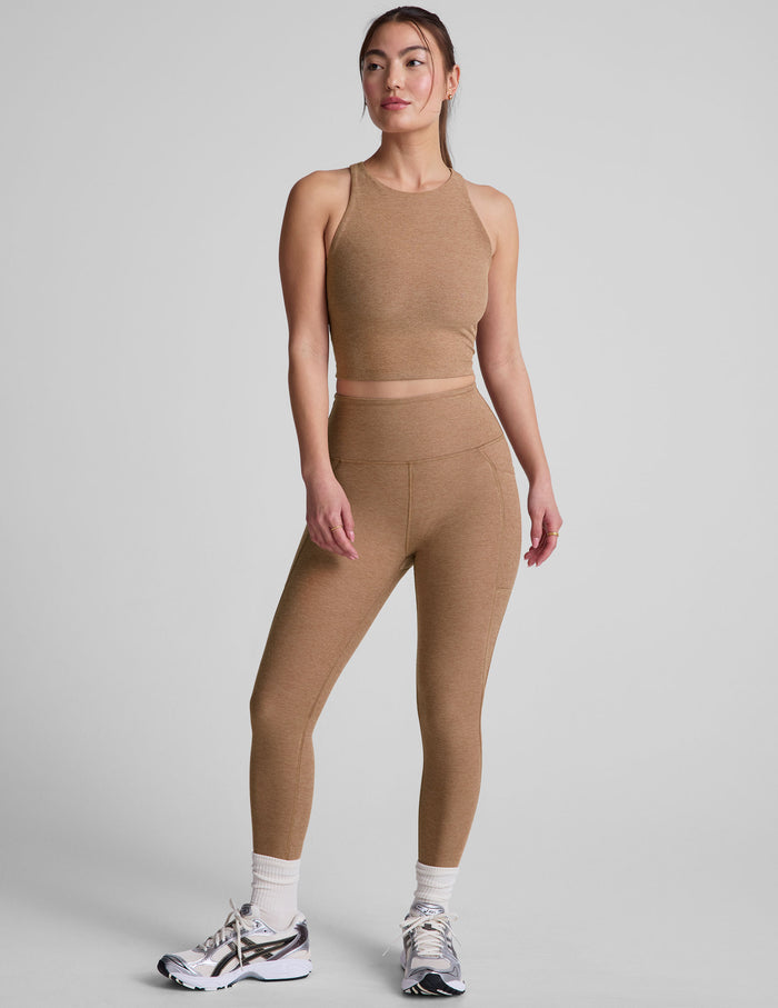 Woman in brown Spacedye Out Of Pocket High Waisted Capri Legging with side pockets, matching top and sneakers.