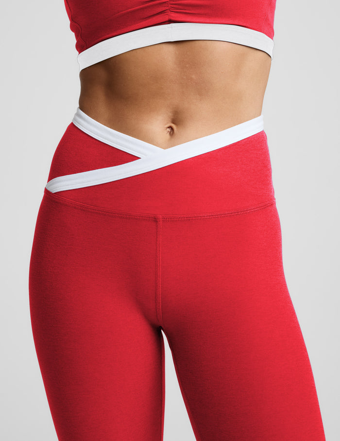 Woman wearing a red athletic outfit on a light gray background.