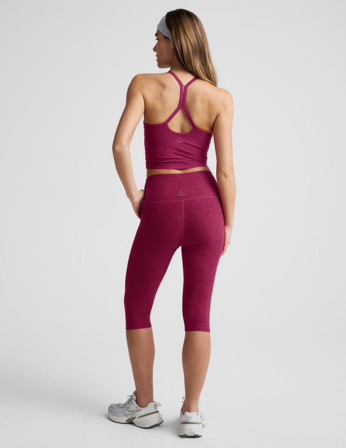 Back view of maroon Spacedye Pedal Pusher High Waisted Legging on a model, cropped below the knee in a heathered fabric.