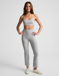 Woman wearing gray marled Spacedye Pintuck Kick Flare High Waisted Pant with front pintuck seams and cropped flared hem.
