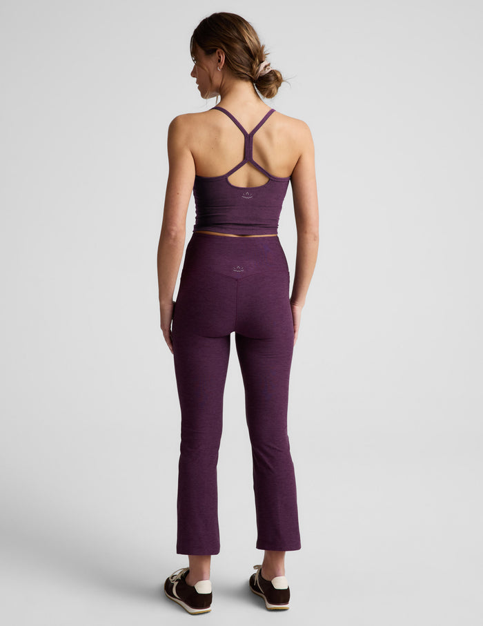 Rear view of woman wearing Purple Spacedye™ Pintuck Kick Flare High Waisted Pant paired with a matching cropped tank top.