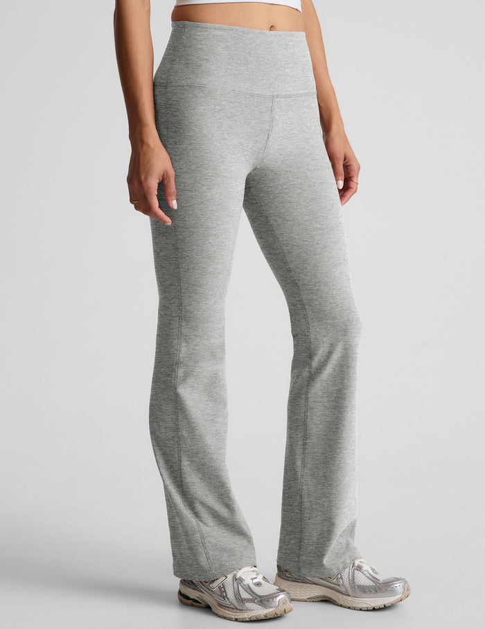 Light gray marled Spacedye Practice High Waisted Bootcut Pant featuring a wide waistband and flared hem, shown on a model.