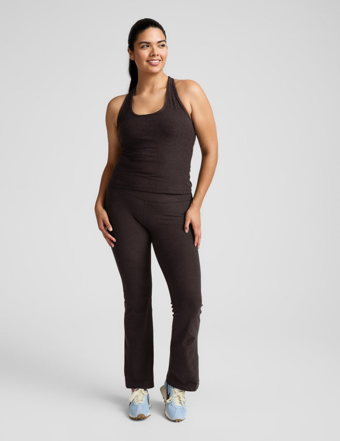 A woman wears the marled brown Spacedye Practice High Waisted Bootcut Pant with a flared leg and wide waistband.