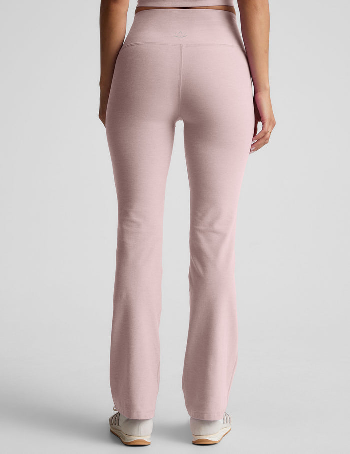 Rear view of light pink Spacedye Practice High Waisted Bootcut Pant showing the snug fit and flared leg openings.