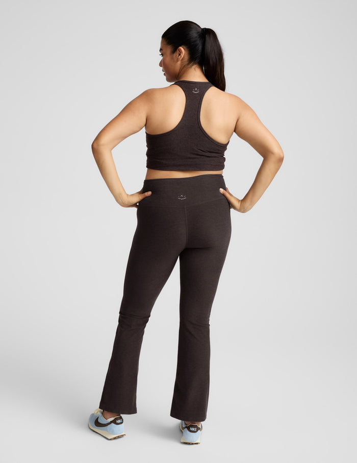 Rear view of a woman wearing the brown marled Spacedye Practice High Waisted Bootcut Pant with a matching racerback top.